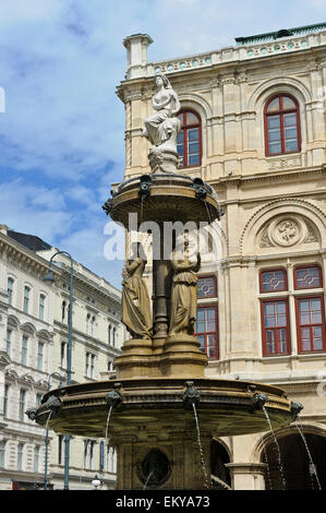 Una fontana di acqua con sculture al di fuori dello Stato Teatro dell'Opera, Vienna, Austria. Foto Stock