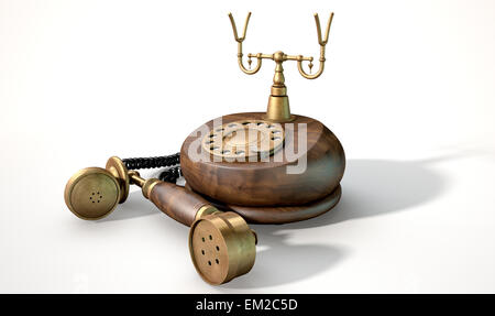 Un vintage in legno e ottone con telefono dial abbellimenti e il ricevitore giacente fuori il gancio su un isolato bianco backg studio Foto Stock