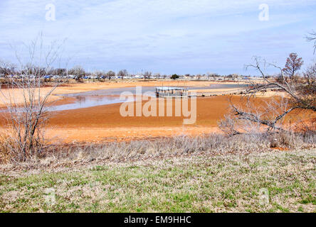 Un dock di pesca è a filamento di sinistra nel fango e acqua bassa in colpite dalla siccità Lago Hefner, Oklahoma City, Oklahoma, Stati Uniti d'America Foto Stock