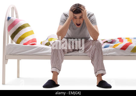 Giovane uomo che soffrono di insonnia isolata contro uno sfondo bianco Foto Stock