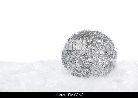 Argento palla di Natale sulla neve isolato su sfondo bianco con Foto Stock