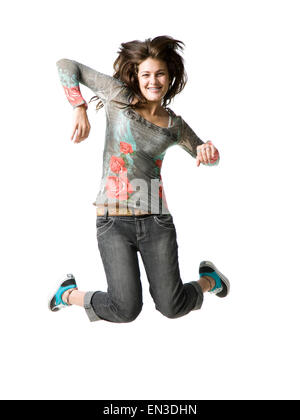 Ritratto in studio della ragazza adolescente (16-17) jumping, sorridente Foto Stock