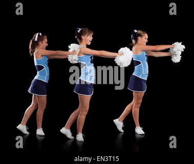 Studio shot di cheerleaders (16-17) dancing Foto Stock