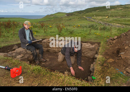 Gli archeologi che lavorano presso Dunluce Castle Foto Stock