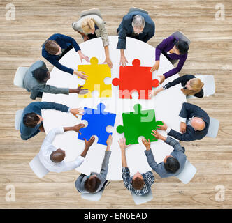 La gente di affari con i pezzi del puzzle e il concetto di lavoro di squadra Foto Stock