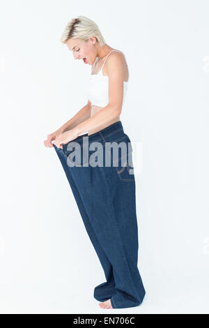 Sorpreso bionda anche indossare pantaloni di grandi dimensioni Foto Stock