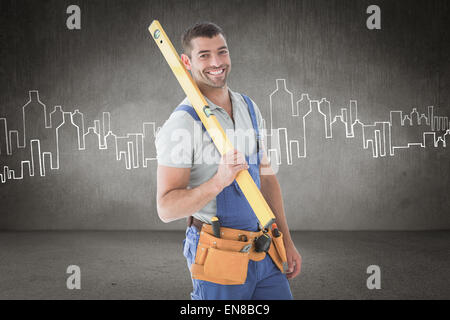Immagine composita di lavoratore mantenendo la livella Foto Stock