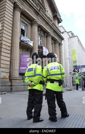 Liverpool, Regno Unito. Il 3 maggio, 2015. Durante una dimostrazione dai sostenitori della professione, alimenti e bevande è passata attraverso le ringhiere per gli attivisti rimanendo all'interno dell'ex edificio della banca. Esse sono state occupando a partire dal mese di aprile 18th, e hanno usato l edificio per senzatetto e gente di strada, dando loro riparo e cibo. L'edificio precedentemente era stato lasciato vuoto per 11 anni. Ufficiali di polizia di guardia al di fuori dell'occupato il credito bancario: David Colbran/Alamy Live News Foto Stock