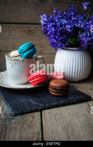 Amaretti colorati sul vecchio sfondo di legno Foto Stock