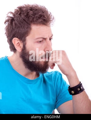 Sorridente giovane uomo con la barba in posa con la maglietta blu Foto Stock