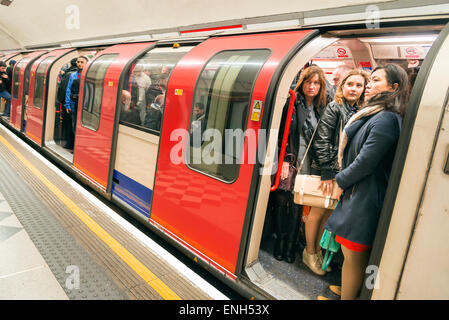 Pendolari che viaggiano su sovraffollato Central Line della metropolitana di Londra trasporto durante la mattina ora di punta, England, Regno Unito Foto Stock