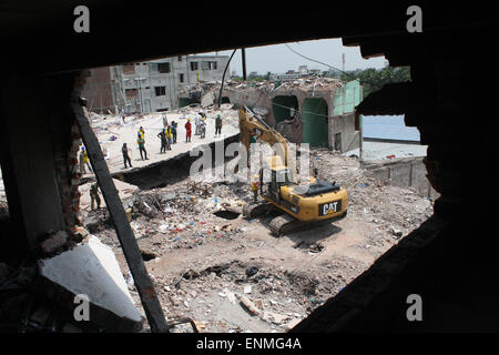 Bangladesh soccorritori look per i superstiti e vittime in corrispondenza del sito di un edificio che è collassata in Savar, vicino a Dacca in Bangladesh. Foto Stock