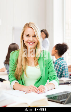 Studente sorridente ragazza con notebook a scuola Foto Stock