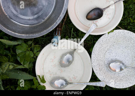 Piatto sporco ware sull'erba Foto Stock