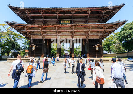 Il massiccio Nandai mon in legno, la Grande porta del Sud, al tempio Todai-ji a Nara, Giappone. Sole luminoso, cielo blu e turisti in visita. Foto Stock