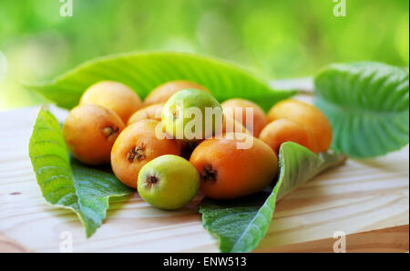 Maturo e saporito Loquats con foglia verde Foto Stock