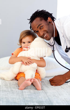 Caring giovane medico con cute girl Foto Stock