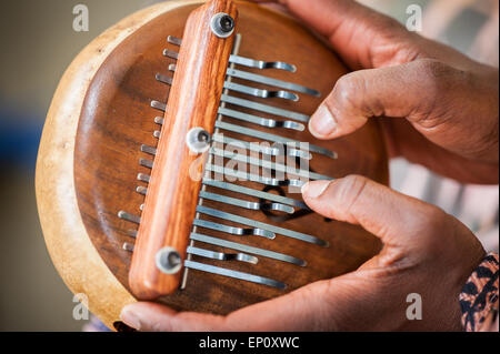 Close-up di African American mani giocando un lamellophone strumento musicale Foto Stock
