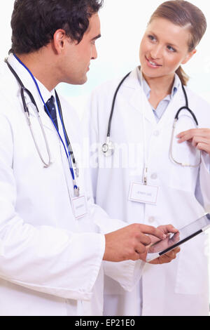 Medici assistenti parlando di ciò che è il tablet Foto Stock