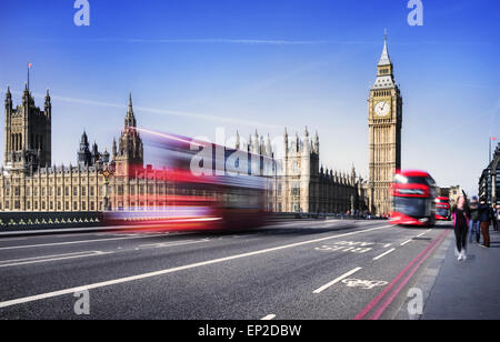 Londra, Regno Unito. Bus rosso in movimento e il Big Ben e il Palazzo di Westminster. Le icone di Inghilterra nel vintage, uno stile rétro Foto Stock