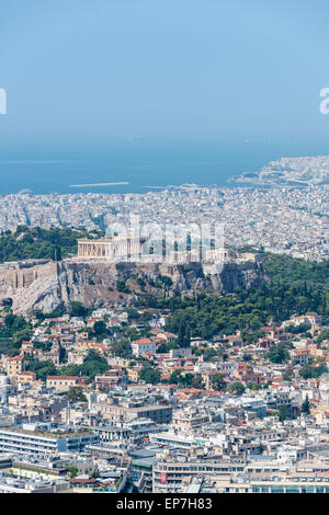 Il Partenone dell'antica Acropoli di Atene prelevato dalla sommità del Monte Lycabettus guardando verso il basso attraverso la città di tetti Foto Stock