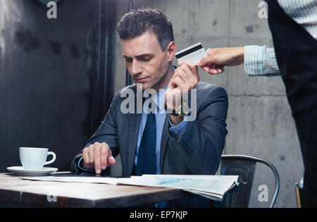 Fiducioso uomo pagando con carta di credito presso il ristorante Foto Stock