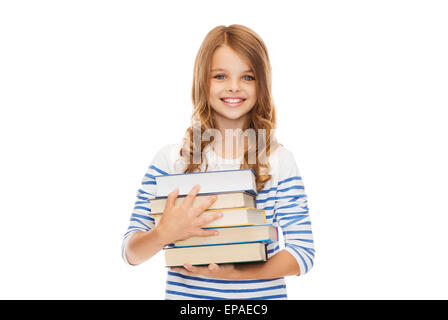 Piccolo studente ragazza con molti libri Foto Stock