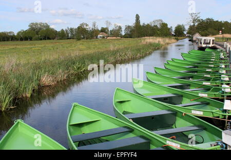 Fila di barche per i turisti ormeggiata in un canale vicino al famoso villaggio di Giethoorn, Overijssel, Paesi Bassi Foto Stock