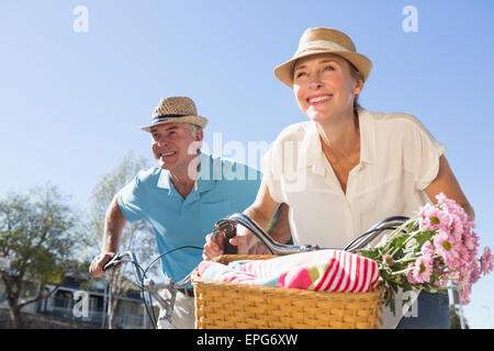 Felice coppia senior di andare per un giro in bicicletta in città Foto Stock