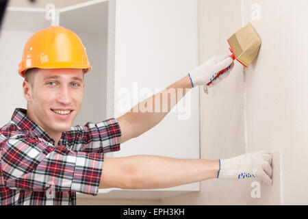 Giovane lavoratore con spazzola di vernice Foto Stock