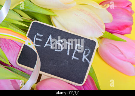 Nastro di pasqua, tulipani e piccole di Blackboard Foto Stock