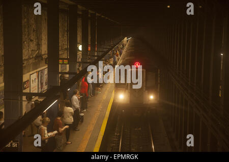 Pendolari dall'Hunter College quartiere attendere yhe trin 6 sulla linea di Lexington a Sessantottesima strada in NYC. Foto Stock