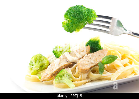 Chicken Fettuccini alfredo con foglie di basilico fresco e cotto a vapore broccoli freschi, deliziosa Foto Stock