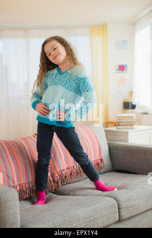 Ritratto di ragazza (10-11) in posa sul divano Foto Stock
