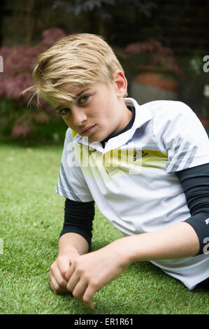 Un giovane ragazzo guarda nella telecamera Foto Stock