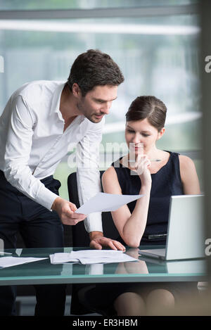 I colleghi che lavorano insieme in ufficio Foto Stock