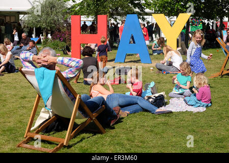 Festival di fieno, POWYS, GALLES - Hay 2015 - Half Term divertente per i bambini presso il Festival di fieno come essi corrono intorno prati e giocare sul gigante segno di fieno. Il festival letterario ha molte sessioni e gli eventi per gli autori di libri per bambini per giovani lettori a partecipare. Foto Stock