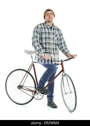 Giovane uomo fare trucchi su ingranaggio fisso bicicletta su sfondo bianco Foto Stock