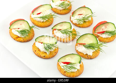 Piastra di snack di cracker conditi con pomodoro aneto di cetriolo e formaggio Foto Stock