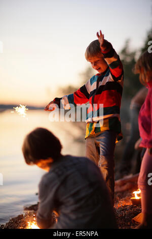 I bambini con botti in riva al lago di Starnberg, Ammerland, Munsing, Alta Baviera, Germania Foto Stock