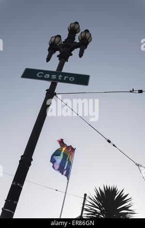 Basso angolo vista di Castro strada segno e bandiera arcobaleno contro il cielo chiaro Foto Stock