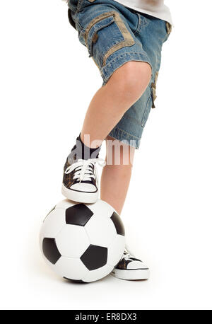 I piedi calzati in sneakers e pallone da calcio studio isolato Foto Stock