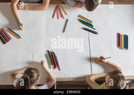 Angolo di alta vista di disegno per bambini su carte in tavola Foto Stock