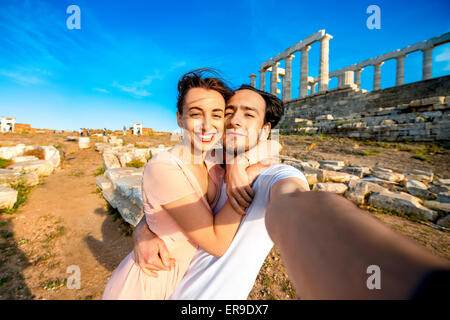 Tourist coppia giovane vicino al tempio di Poseidone in Grecia Foto Stock