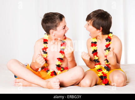 Due ragazzi con la bandiera tedesca sta guardando una partita e totalmente eccitato Foto Stock