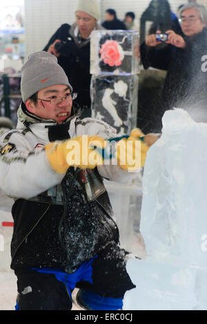 Un ghiaccio opere dello scultore su una scultura di ghiaccio in corrispondenza della porzione di Susukino di il Festival annuale della neve a Sapporo, Hokkaido, Giappone Foto Stock