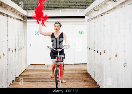 I vecchi donna caucasica equitazione Bicicletta sul dock in legno Foto Stock