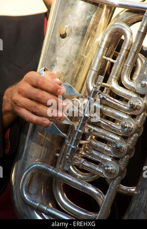 Close-up di bass tubista della mano destra sulle valvole. Foto Stock