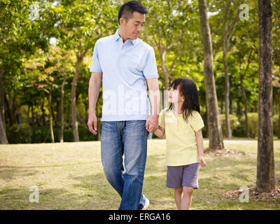 Asian padre e figlia facendo una passeggiata nel parco Foto Stock