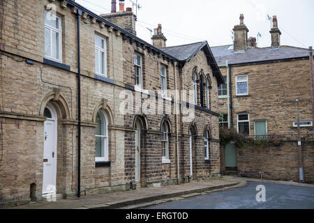 Case a schiera in una tipica strada nel sito del Patrimonio Mondiale di Saltaire, Bradford, West Yorkshire, Inghilterra Foto Stock